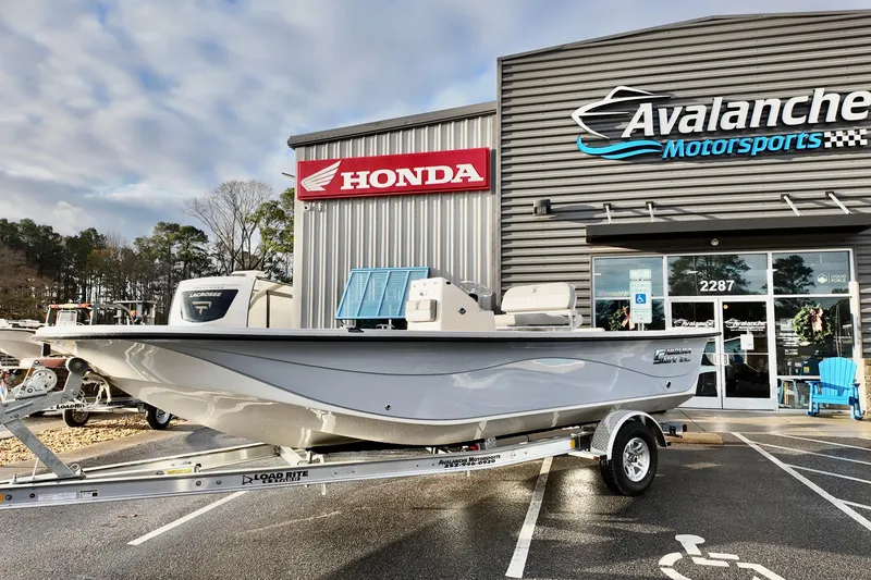 The Image of 2026 Carolina Skiff 21 LS boat on trailer at Avalanche Motorsports dealership. - 1