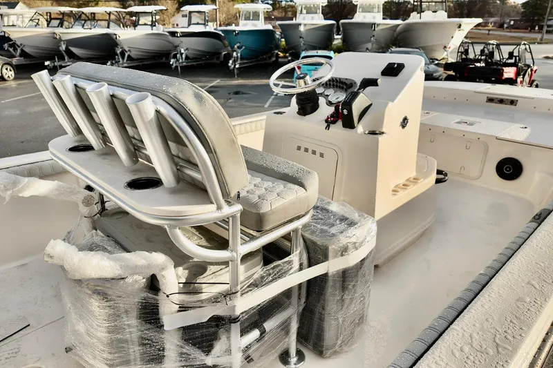Slide: The Image of 2026 Carolina Skiff 21 LS boat interior with helm and seating, wrapped for protection. - 6