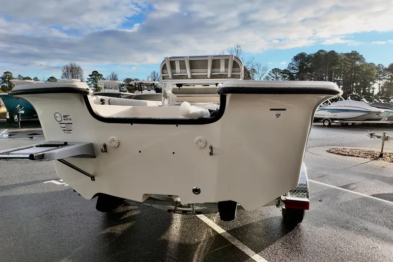 Slide: The Image of 2026 Carolina Skiff 21 LS boat rear view in a parking lot. - 7