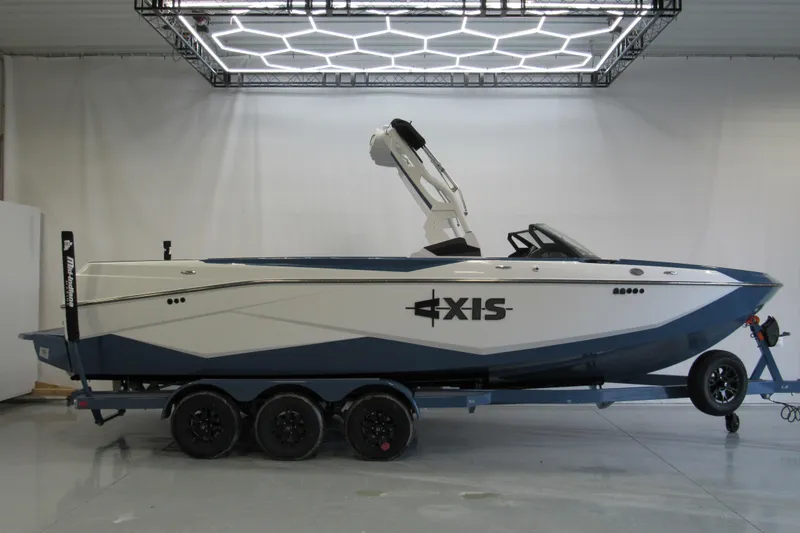 The Image of 2026 Axis T250 boat on trailer in indoor showroom setting. - 0