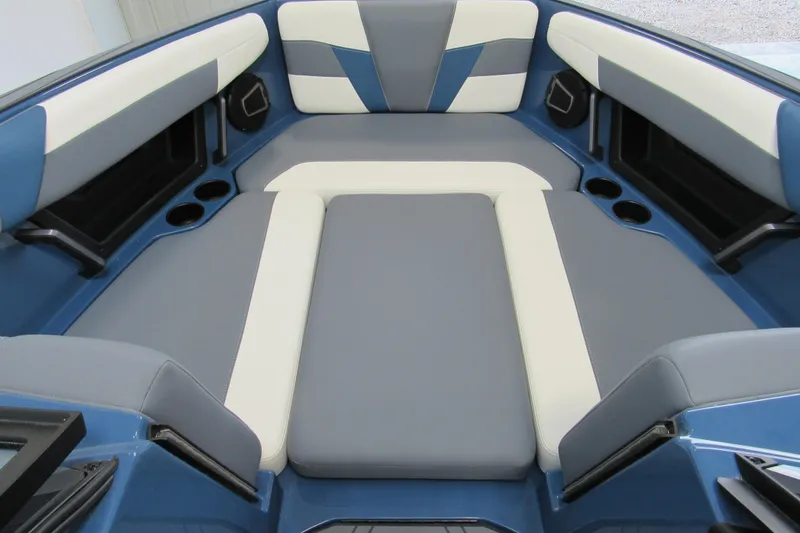 Slide: The Image of 2026 Axis T250 boat interior with blue and gray seating, cup holders, and modern design. - 10