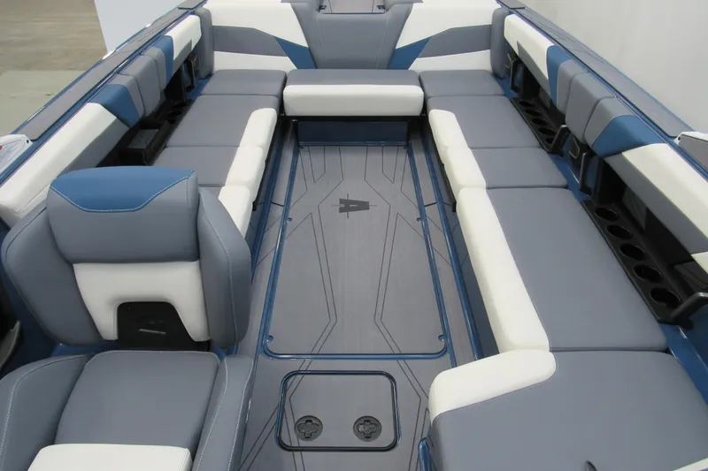 Slide: The Image of 2026 Axis T250 boat interior with blue and white seating, spacious layout. - 11