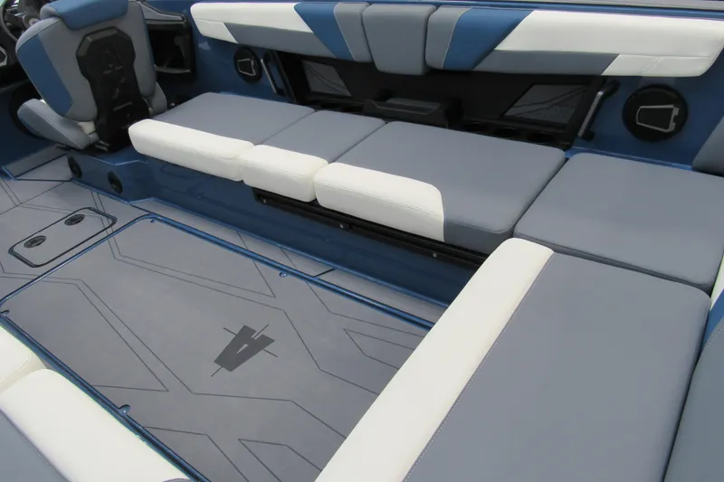 Slide: The Image of 2026 Axis T250 boat interior with blue and white cushioned seating and sleek design. - 7