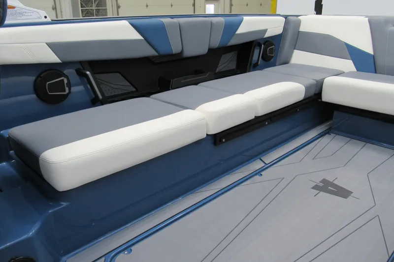 Slide: The Image of 2026 Axis T250 boat interior with blue and white cushioned seating. - 8
