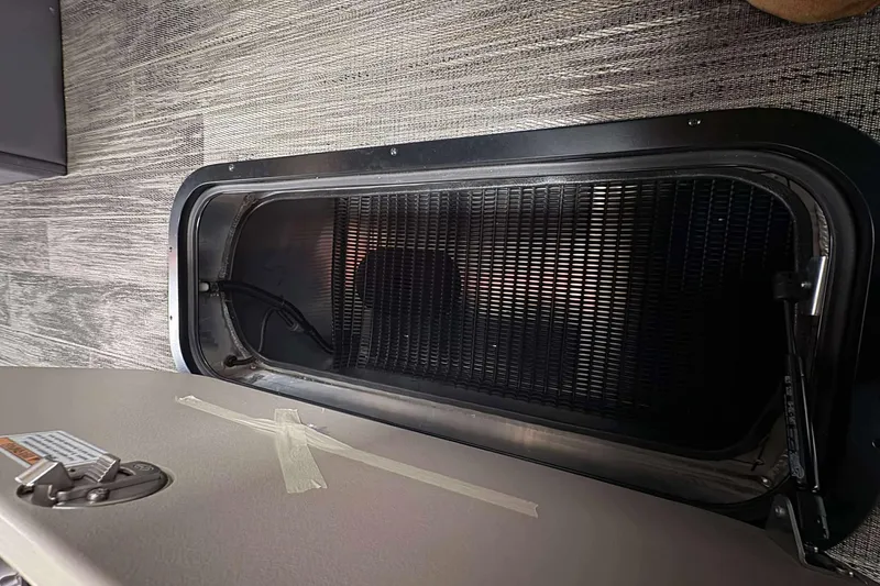 Slide: The Image of Open storage compartment in 2026 Avalon 2385 LSZ boat, showcasing interior details. - 13