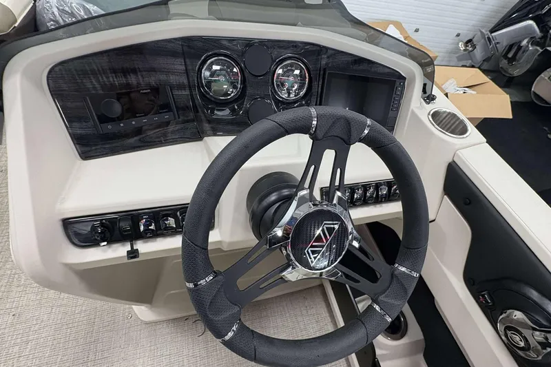 Slide: The Image of Steering wheel and dashboard of 2026 Avalon 2385 LSZ boat, featuring modern controls. - 14