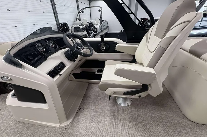 Slide: The Image of 2026 Avalon 2385 LSZ boat interior with modern helm and comfortable captain's chair. - 15