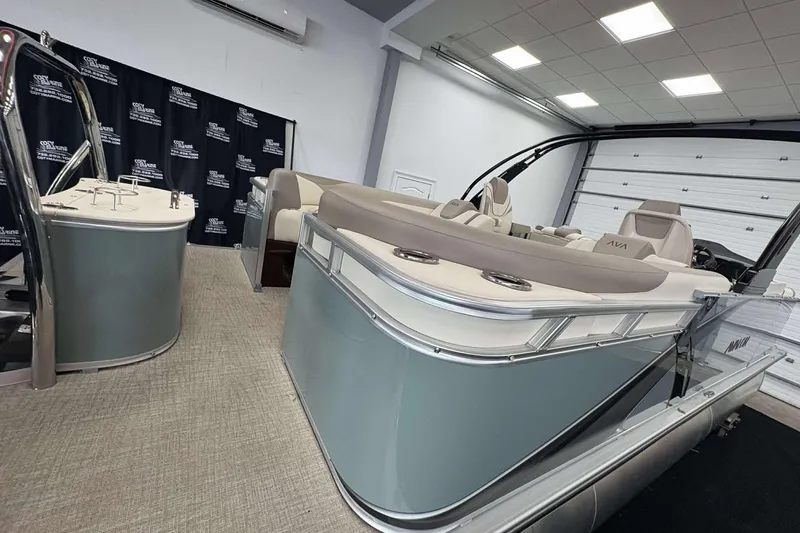 Slide: The Image of 2026 Avalon 2385 LSZ pontoon boat in showroom, featuring sleek design and modern seating. - 23