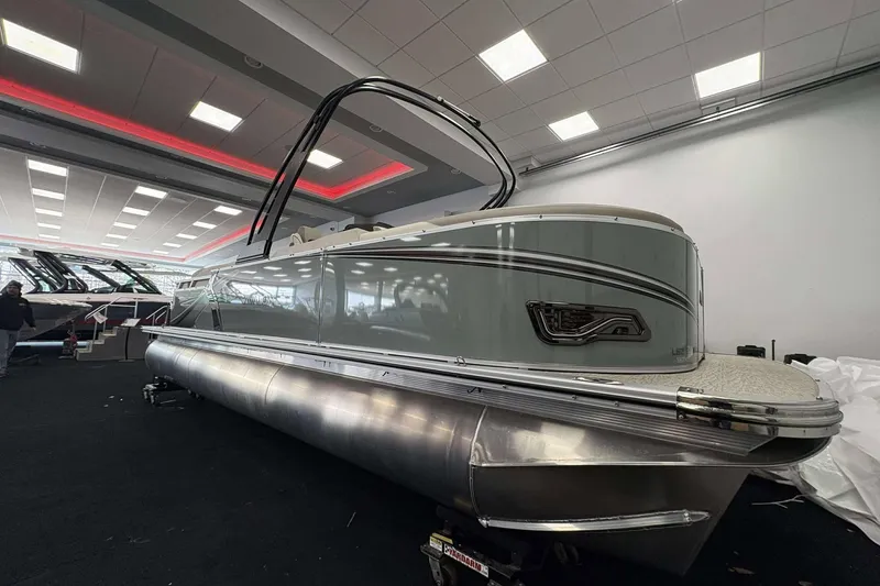 Slide: The Image of 2026 Avalon 2385 LSZ pontoon boat displayed indoors with modern design features. - 4