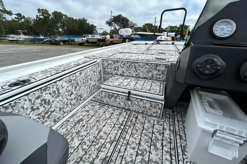 Slide: The Image of 2023 Crestliner 1600 Storm boat interior with camo design and control panel. - 13