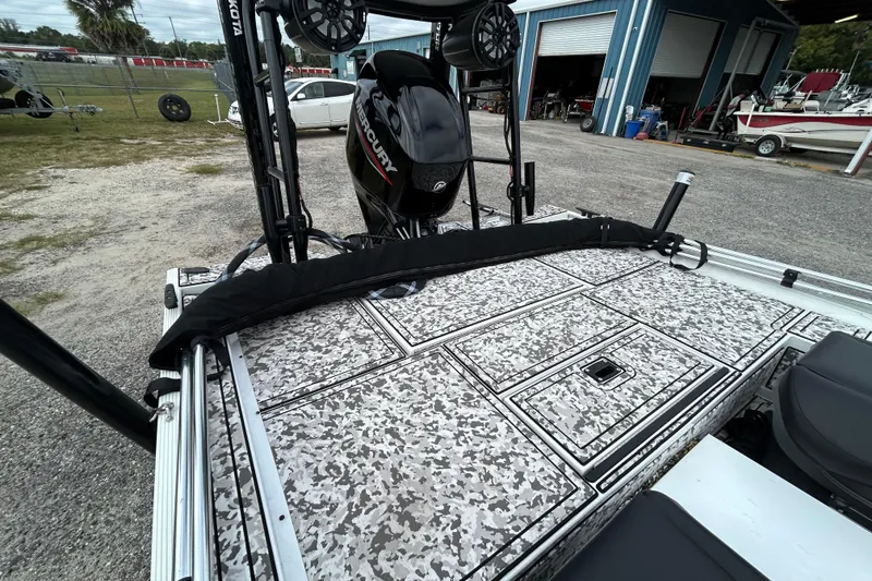 Slide: The Image of 2023 Crestliner 1600 Storm boat with Mercury engine, camo deck, and fishing equipment. - 14