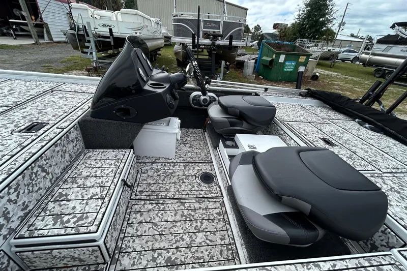 Slide: The Image of 2023 Crestliner 1600 Storm boat interior with camo design and dual seating. - 17