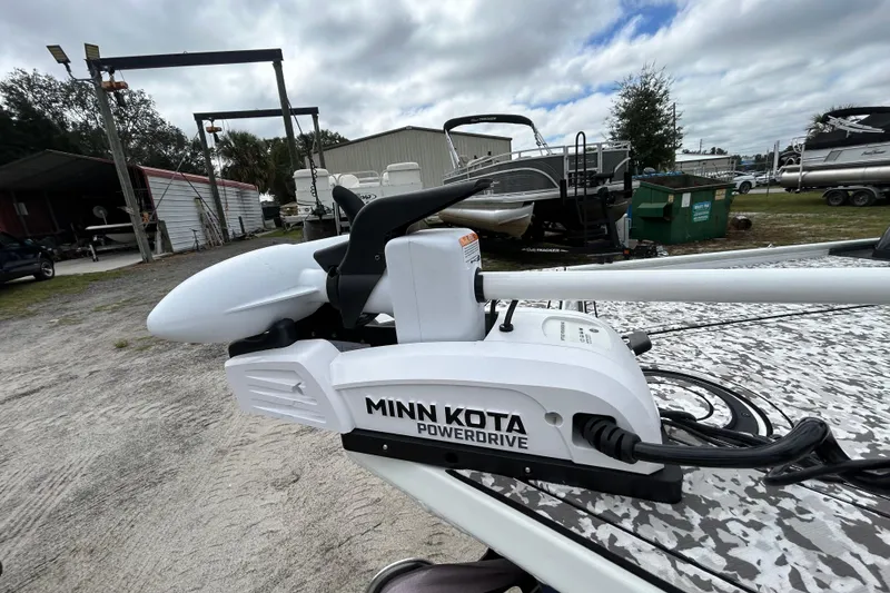 Slide: The Image of 2023 Crestliner 1600 Storm with Minn Kota PowerDrive trolling motor, parked outdoors. - 18