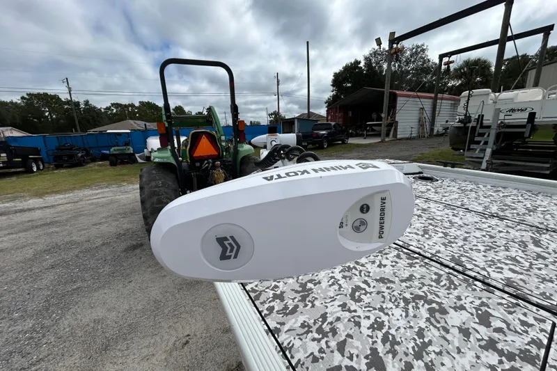 Slide: The Image of 2023 Crestliner 1600 Storm boat with Minn Kota PowerDrive motor in a yard setting. - 19