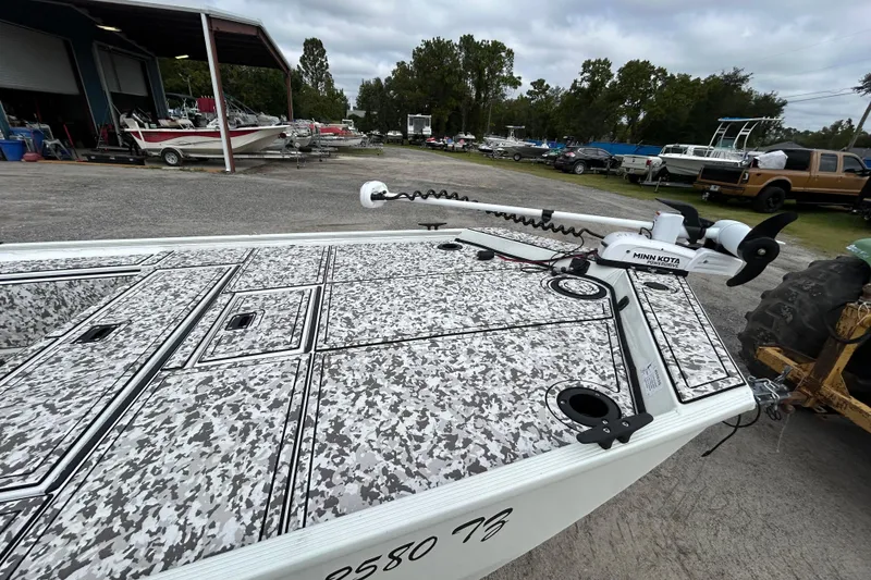 Slide: The Image of 2023 Crestliner 1600 Storm boat with camo deck and Minn Kota trolling motor. - 5