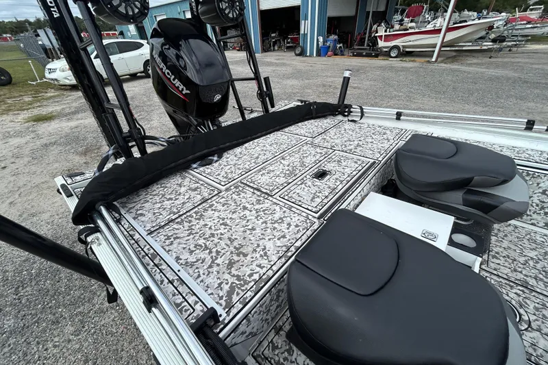 Slide: The Image of 2023 Crestliner 1600 Storm boat with Mercury engine, featuring camo deck and dual seats. - 7