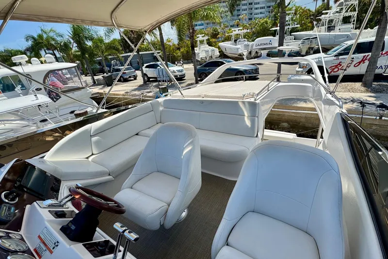 Slide: The Image of Luxurious 2009 Regal 4080 yacht interior with white seating and modern helm. - 10