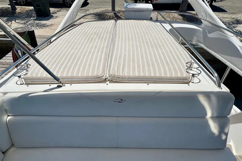 Slide: The Image of Luxury 2009 Regal 4080 boat with cushioned sun deck and stainless steel railings. - 11