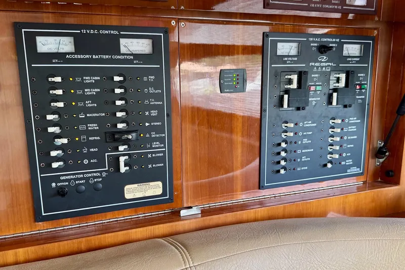 Slide: The Image of Control panel of a 2009 Regal 4080 boat with various switches and gauges. - 16