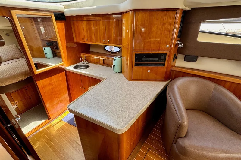 Slide: The Image of Luxurious 2009 Regal 4080 yacht interior with wood cabinetry and modern amenities. - 17