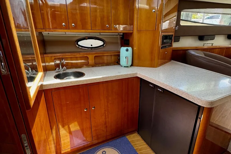 Slide: The Image of Luxurious 2009 Regal 4080 yacht kitchen with wood cabinetry and modern appliances. - 18