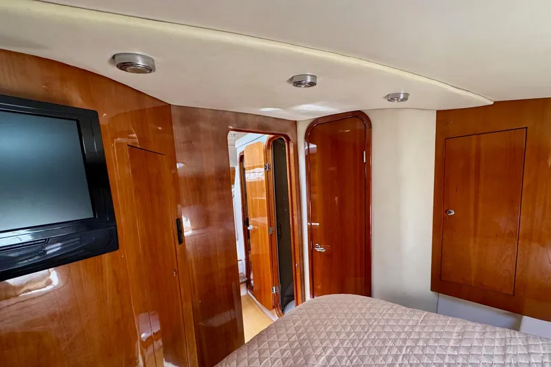 Slide: The Image of Luxurious 2009 Regal 4080 yacht interior with wood paneling and mounted TV. - 23