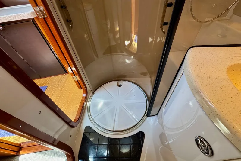 Slide: The Image of Compact bathroom interior of 2009 Regal 4080 yacht, featuring shower and sink. - 26