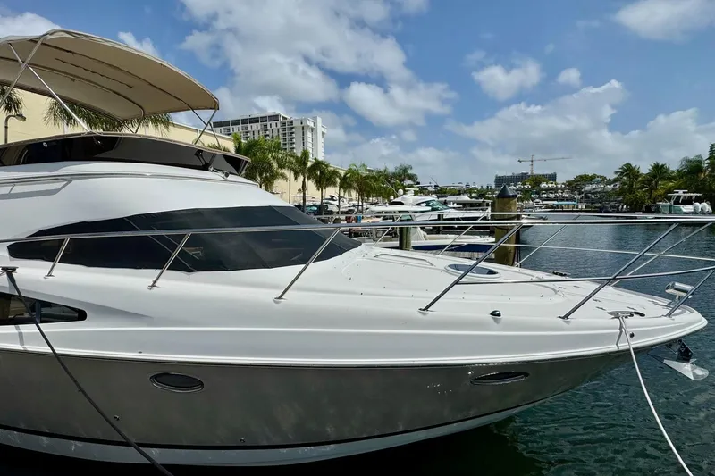 Slide: The Image of Luxury Regal 4080 yacht docked at marina, 2009 model, under clear blue sky. - 4
