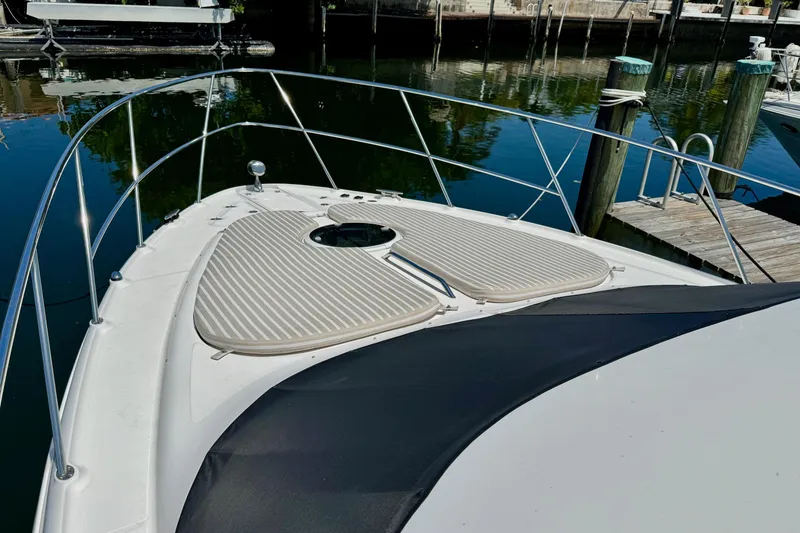 Slide: The Image of Bow of a 2009 Regal 4080 yacht docked at a marina. - 5