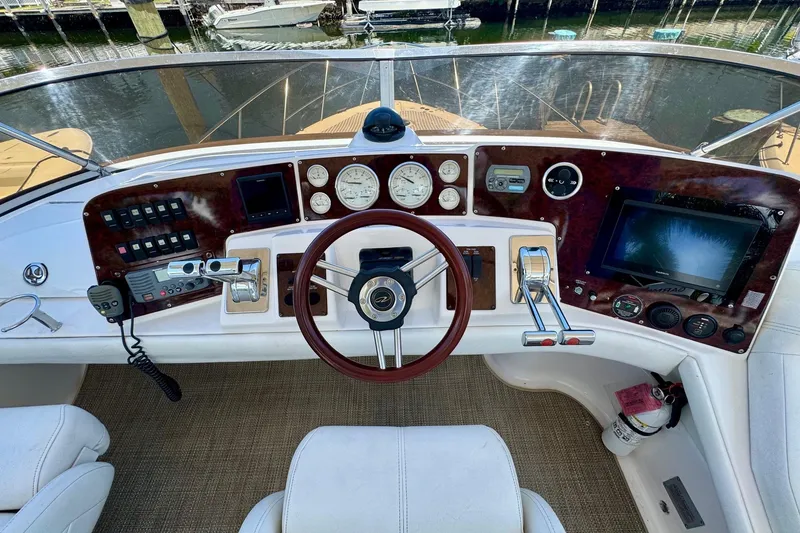 Slide: The Image of Cockpit of 2009 Regal 4080 yacht with steering wheel, gauges, and navigation controls. - 8