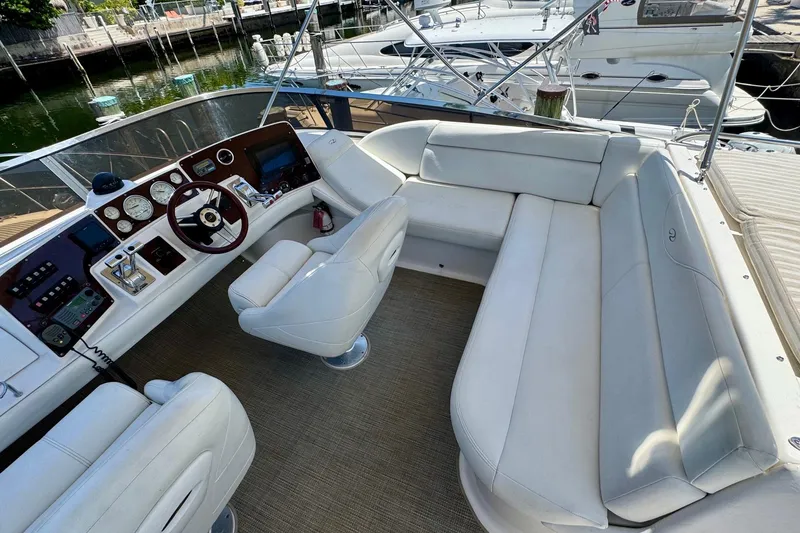 Slide: The Image of Luxurious 2009 Regal 4080 yacht interior with white seating and modern dashboard. - 9