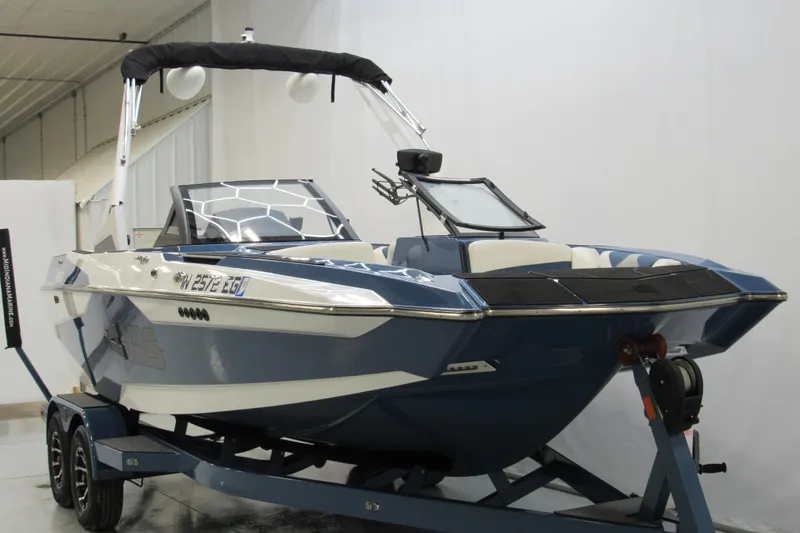 Slide: The Image of 2021 Axis A20 boat on trailer in indoor showroom setting. - 1