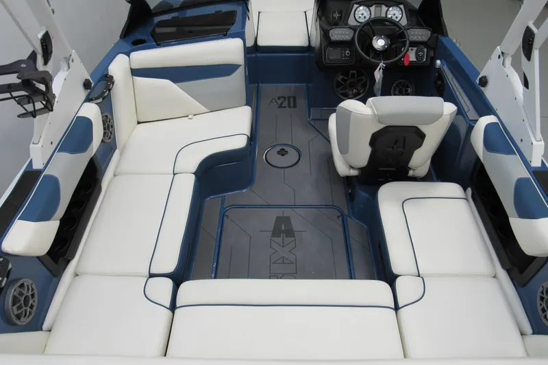 Slide: The Image of 2021 Axis A20 boat interior with white and blue seating, modern dashboard, and spacious layout. - 3