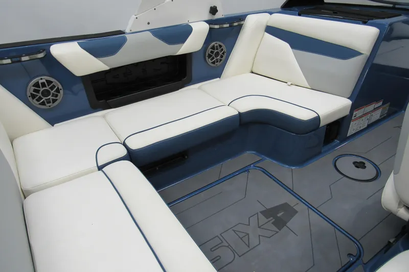 Slide: The Image of 2021 Axis A20 boat interior with white and blue seating, featuring built-in speakers. - 4