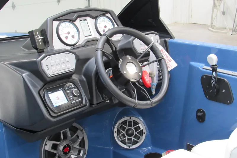Slide: The Image of 2021 Axis A20 boat dashboard with steering wheel, gauges, and control panel. - 8