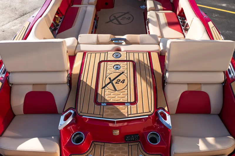 Slide: The Image of 2022 MasterCraft X24 boat interior with red and beige seating, featuring luxury design elements. - 10