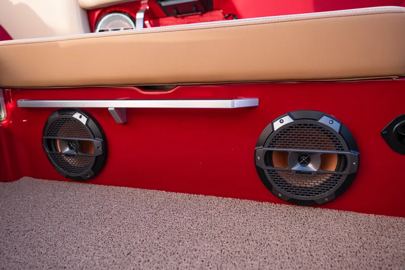 Slide: The Image of 2022 MasterCraft X24 boat interior with red panel and dual speakers. - 26