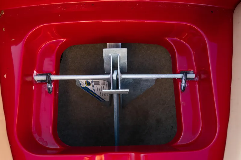 Slide: The Image of Red compartment of 2022 MasterCraft X24 boat with metal latch mechanism. - 29