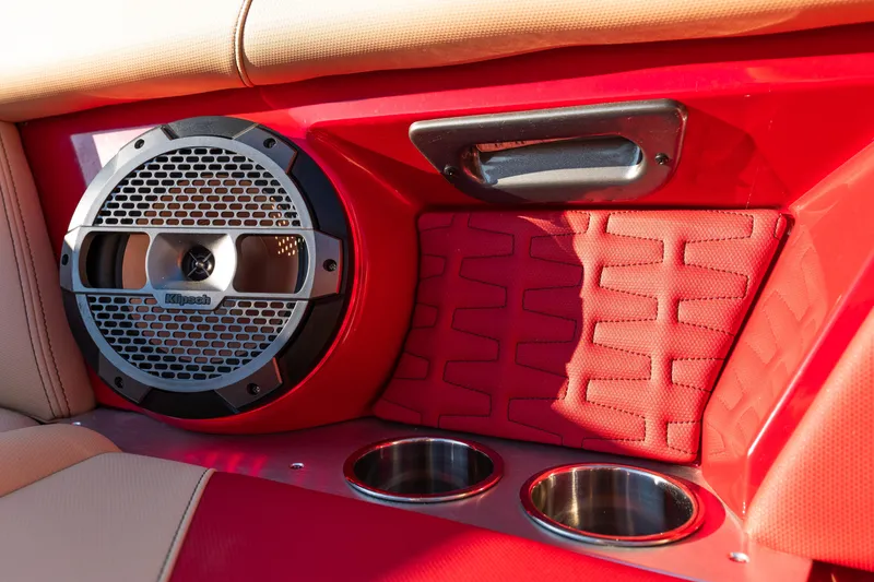 Slide: The Image of Red interior of 2022 MasterCraft X24 boat with Klipsch speaker and cup holders. - 32