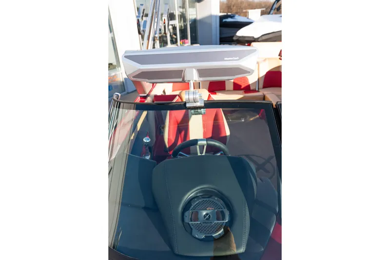 Slide: The Image of 2022 MasterCraft X24 boat dashboard with steering wheel and speaker system. - 36