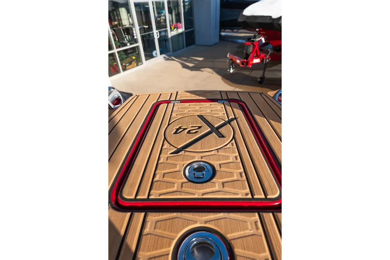 Slide: The Image of 2022 MasterCraft X24 boat deck with stylish wood and red accents. - 40