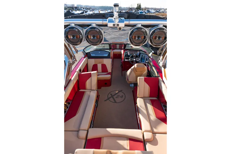 Slide: The Image of Interior of 2022 MasterCraft X24 boat with red and beige seating, advanced dashboard. - 43