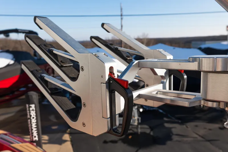 Slide: The Image of 2022 MasterCraft X24 boat with sleek metal wakeboard racks in a sunny outdoor setting. - 45