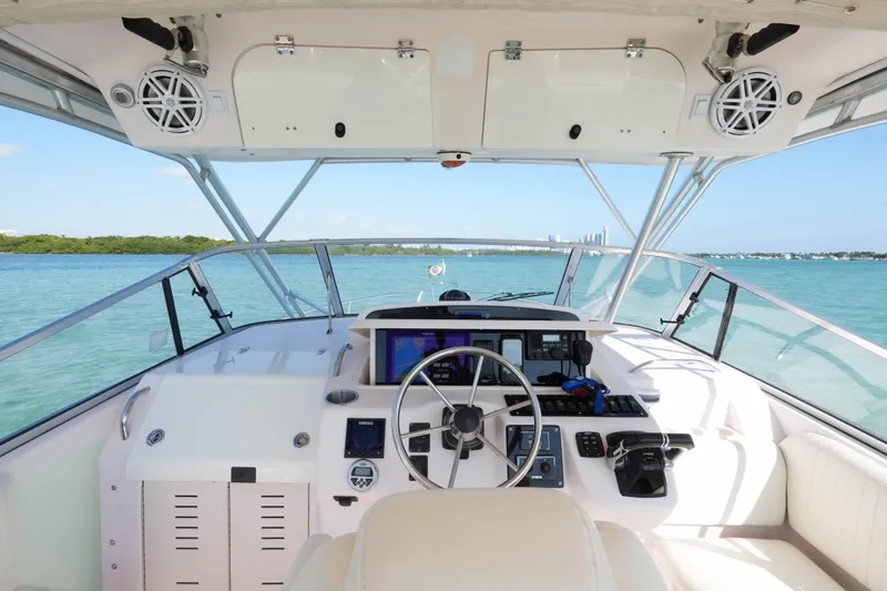 Slide: The Image of 2003 Grady-White Express 330 boat helm with ocean view and modern controls. - 10