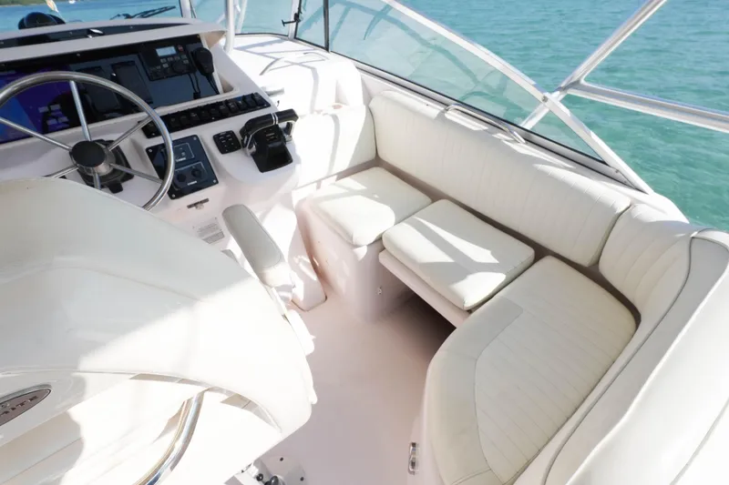 Slide: The Image of 2003 Grady-White Express 330 boat interior with steering wheel and seating area. - 11