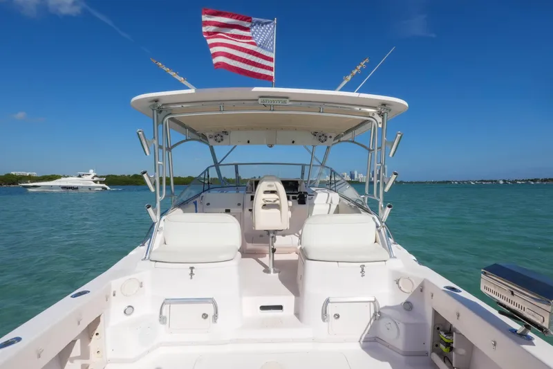Slide: The Image of 2003 Grady-White Express 330 boat with American flag on open water. - 12