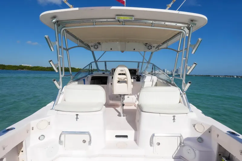 Slide: The Image of 2003 Grady-White Express 330 boat interior with seating, ocean view, and clear blue sky. - 13