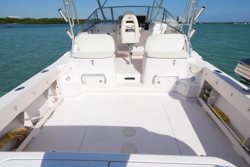 Slide: The Image of 2003 Grady-White Express 330 boat deck with seating, on calm water. - 15