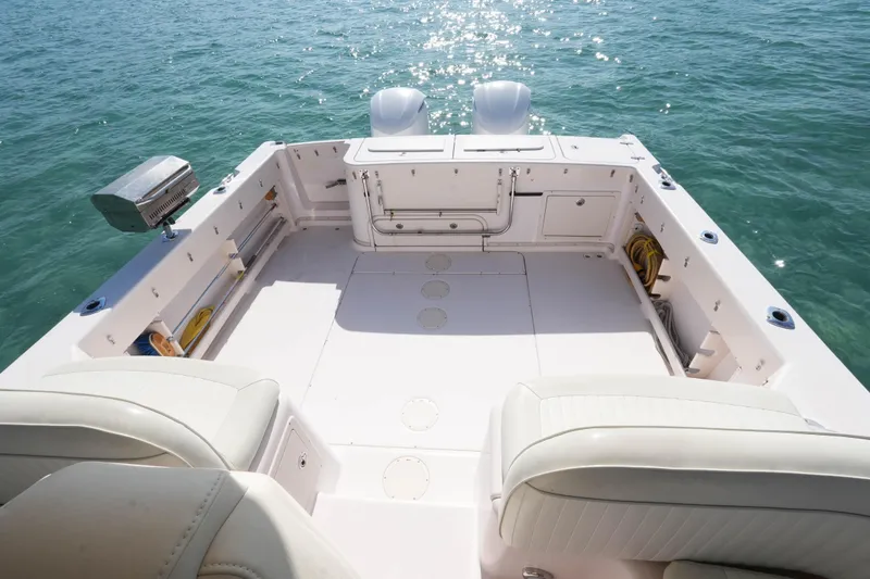 Slide: The Image of 2003 Grady-White Express 330 boat deck with seating, on calm blue water. - 18