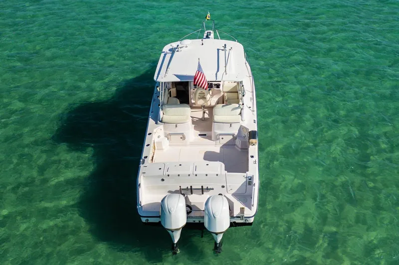 Slide: The Image of 2003 Grady-White Express 330 boat on clear turquoise water, aerial view. - 2